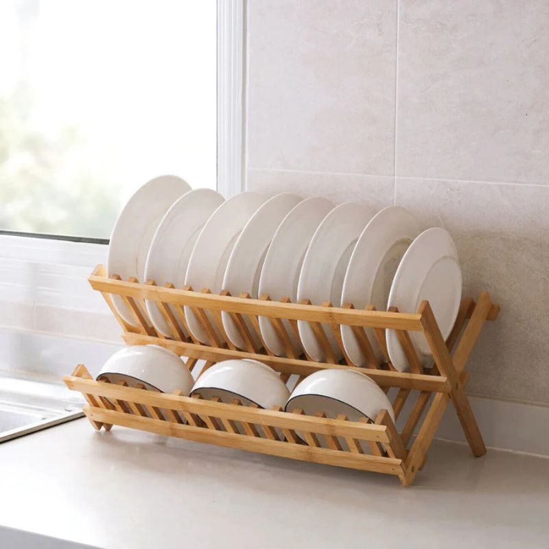 Bamboo dish rack with white plates and bowls.