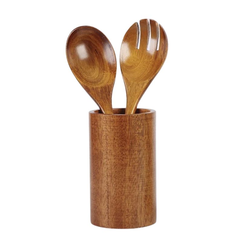 wooden kitchen utensils in cylindrical holder on white surface