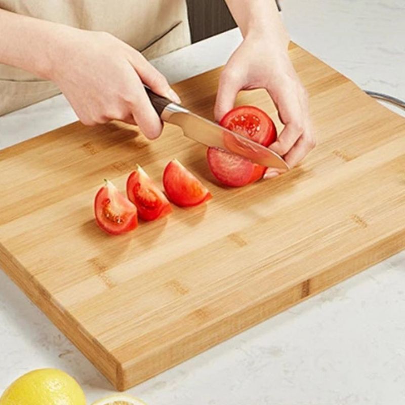 A person cutting tomato.