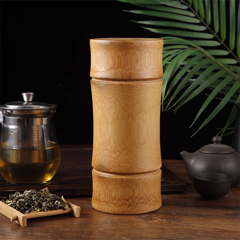 stacked bamboo storage containers beside tea set