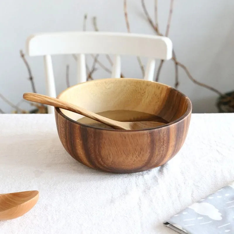 Wooden bowl with a wooden spoon on a white surface