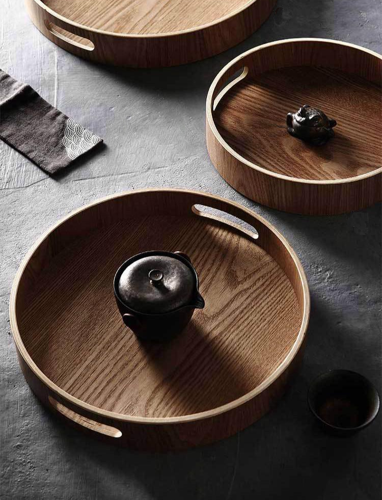 Slim, round serving trays made of wood