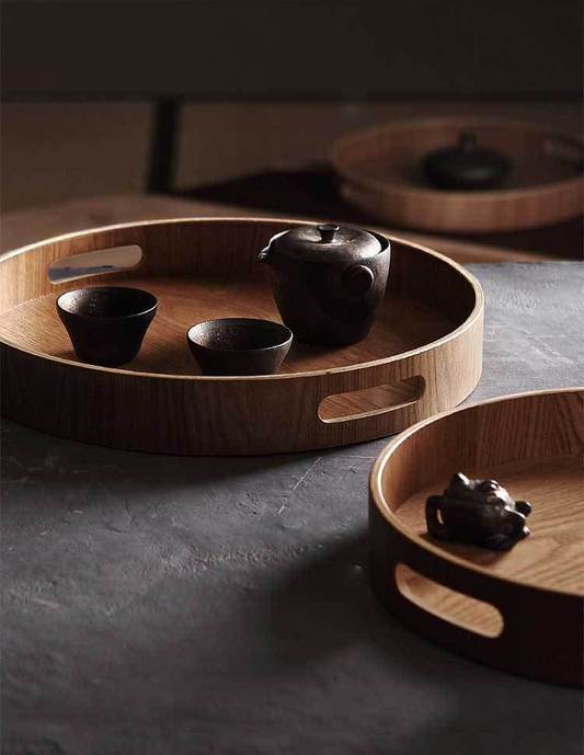 Slim, round serving trays made of wood